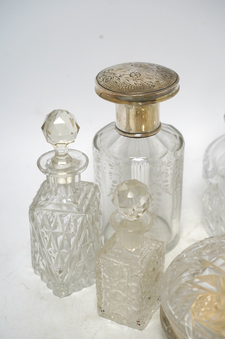 Six cut glass dressing table bottles and bowls, including a bottle with an 800 standard, large white metal cover, 800 standard bottle 16cm high. Condition - fair to good